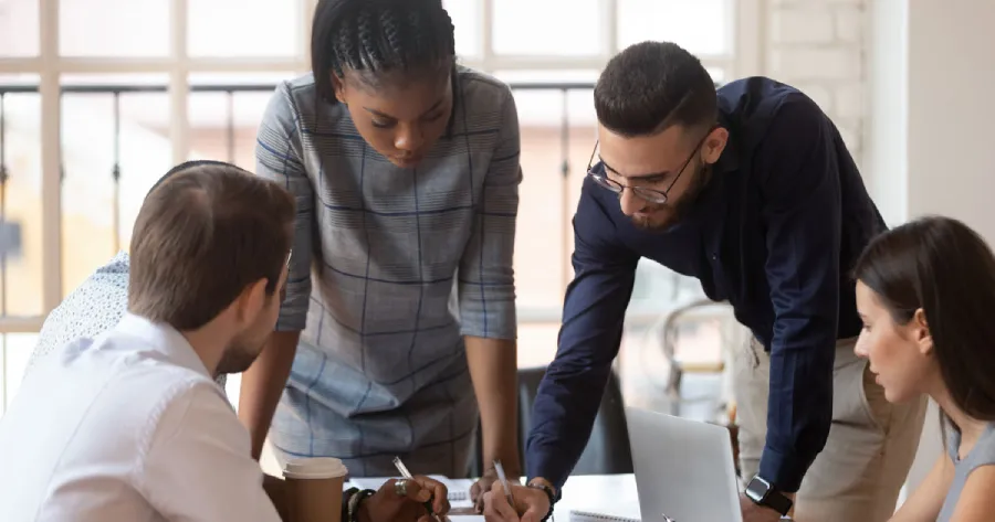 Two women and two men working together.