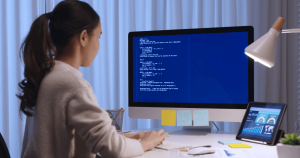 A woman working on a desktop.