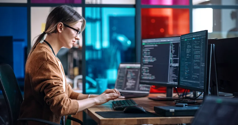  A woman working on a desktop. 