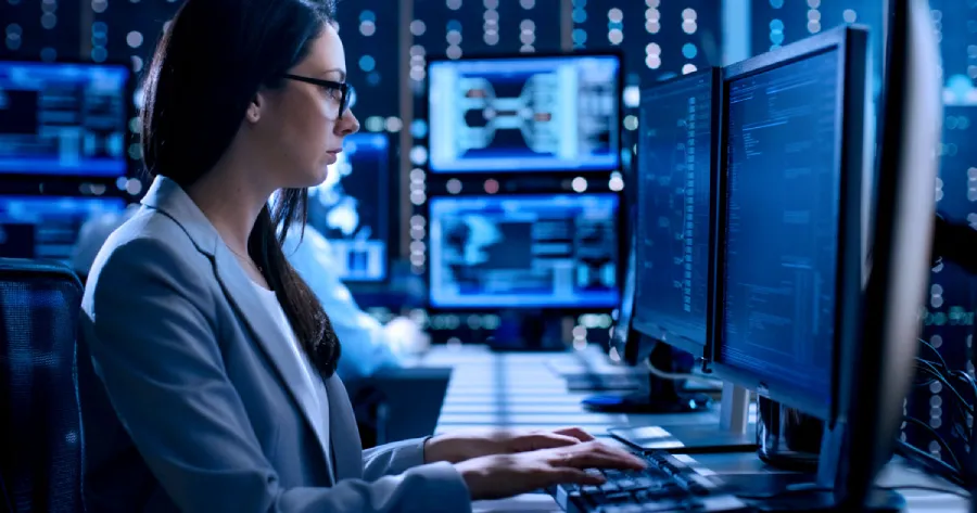 A woman working on data on her desktop. 