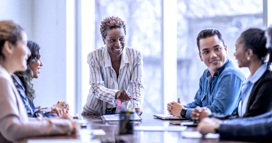 A group of people sitting around a table. 