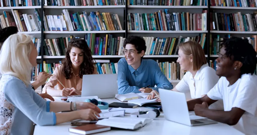 A group of students sitting around a table. 