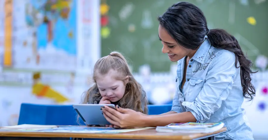 A student and a teacher learning from a tablet.