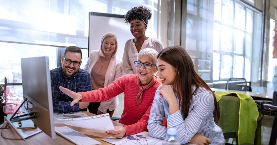 A group of people working together on a table.