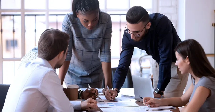 The multiracial corporate business team is discussing the use of AI in the workplace with each other.