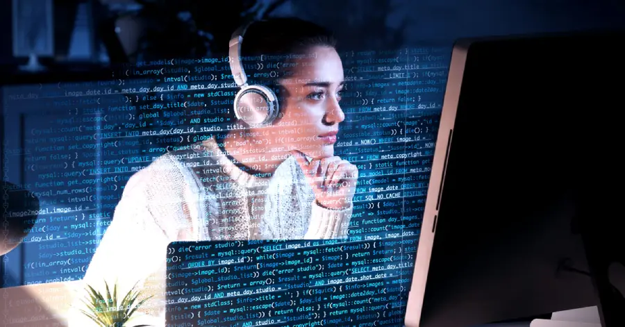 A young woman accessibility testing on her computer at the table.