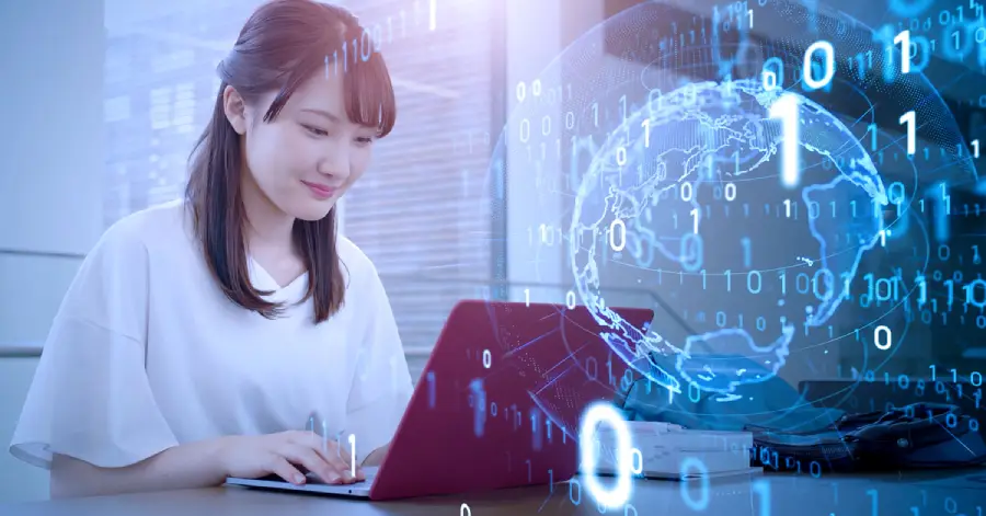 A woman sitting in front of a laptop computer reading about AI Cloud.