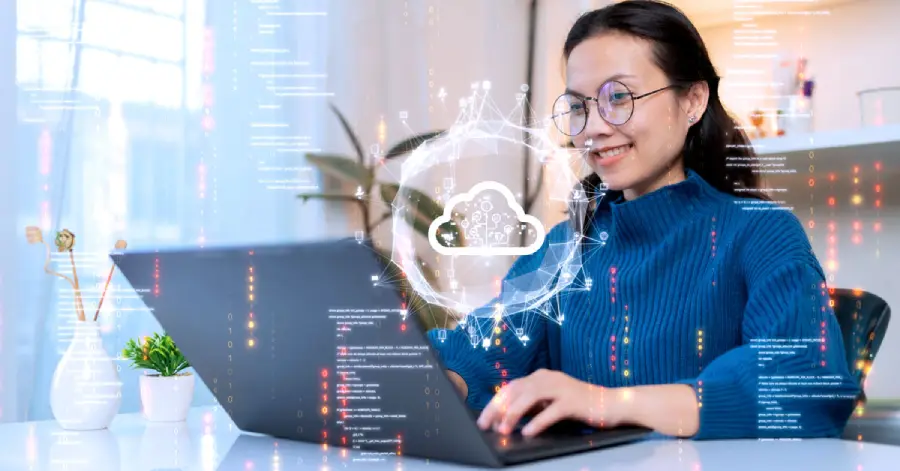  A woman from cloud migration consulting services uploads and transfers data from a computer to a cloud computing platform.