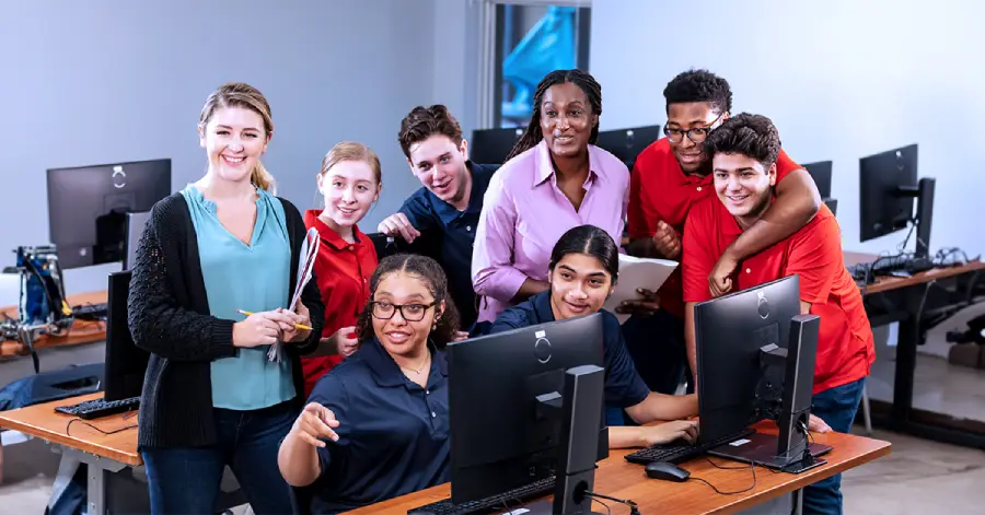 A group of multi-racial students learning together. Along with them are their two teachers. 