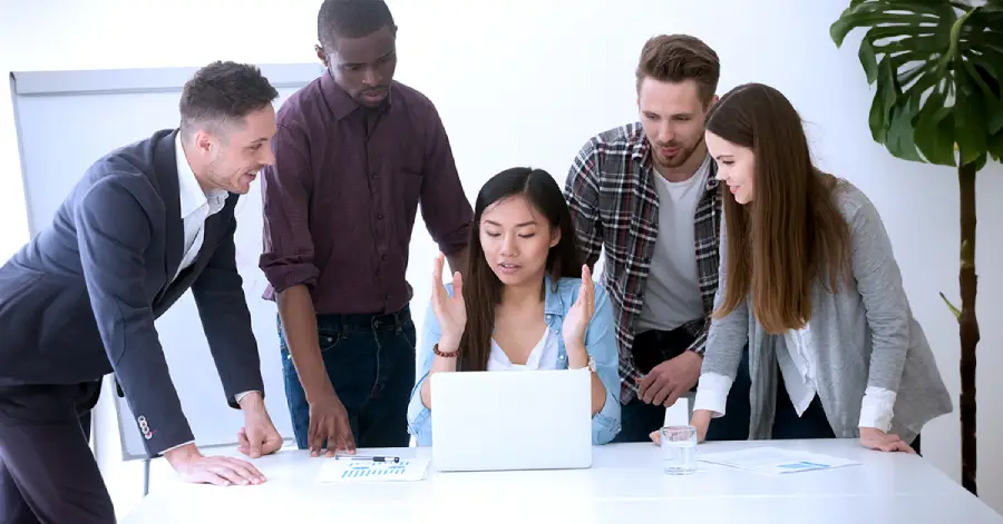 A multiracial group of researchers discussing the benefits of cloud computing in education. 